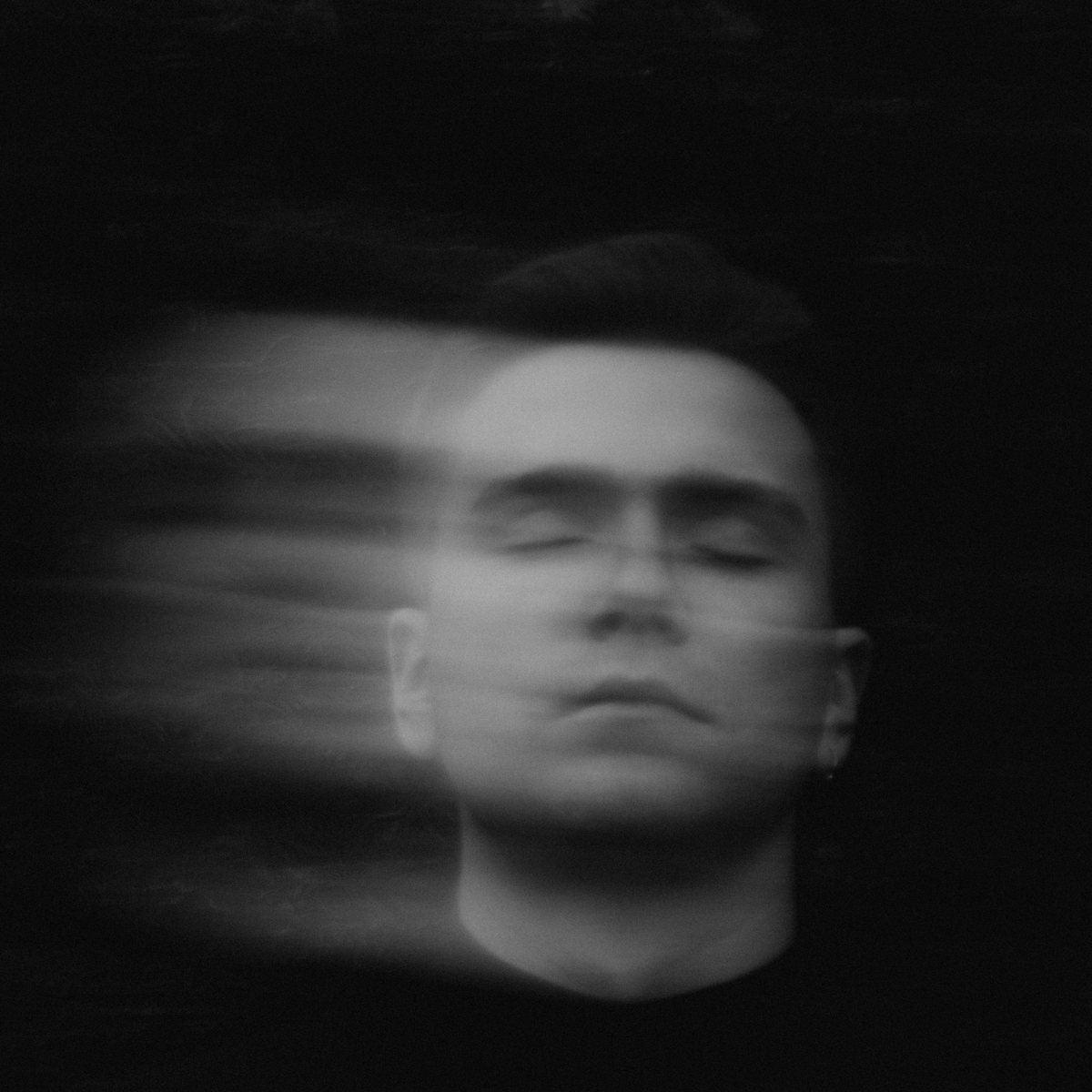 Portrait of a man with motion blur streaking across the frame