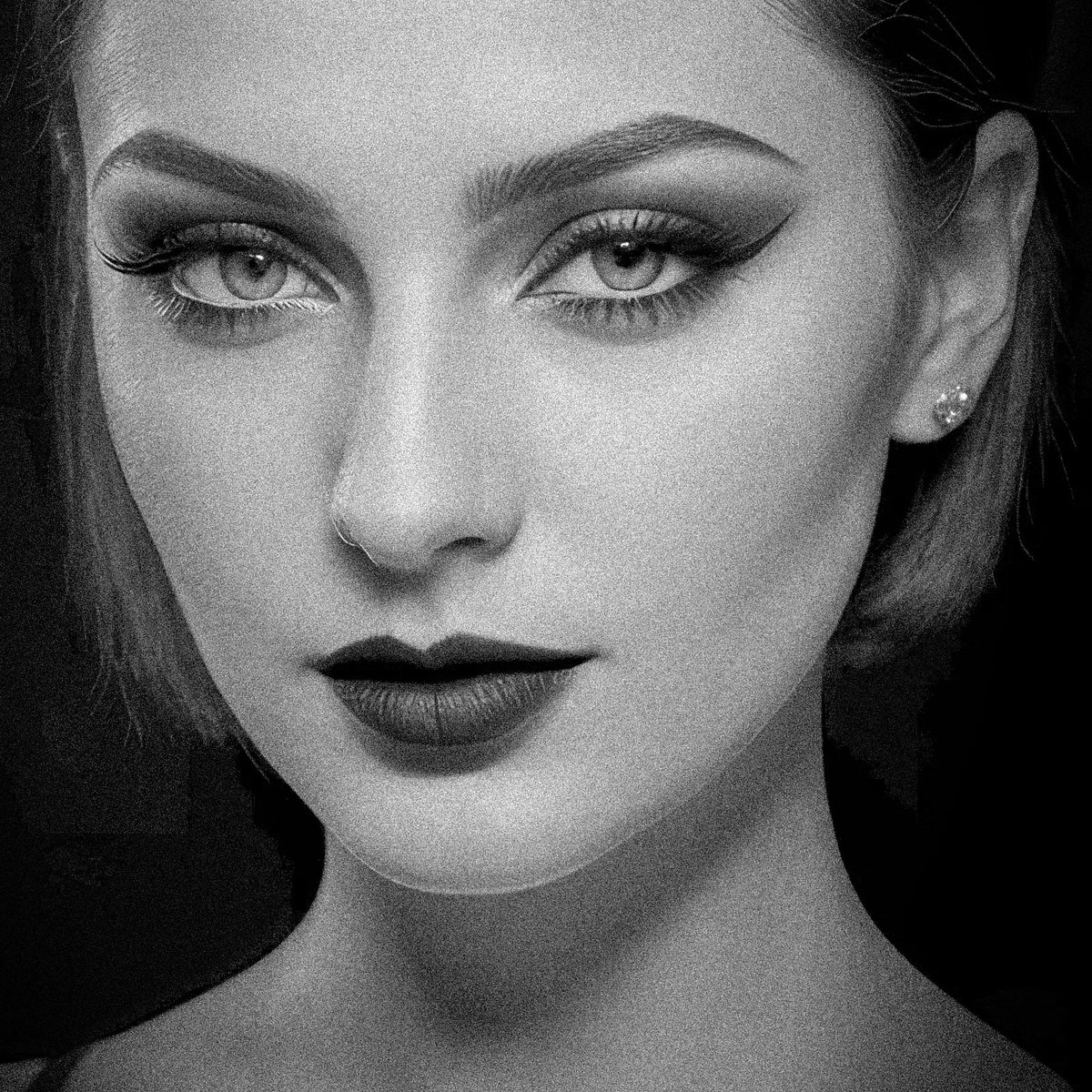 Grainy close-up portrait with winged eyeliner and dark lips