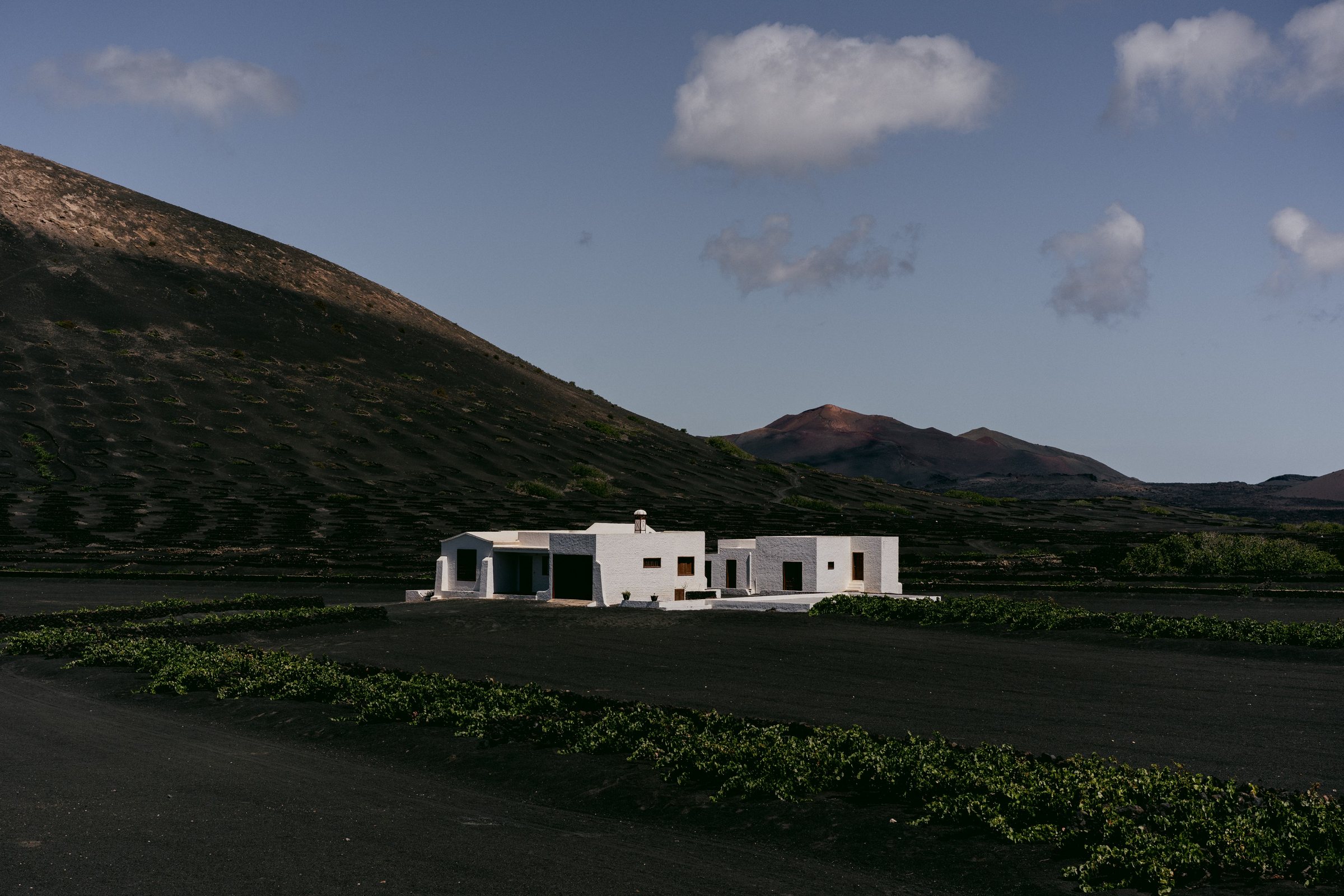 White farmhouse in the black volcanic vine fields of La Geria, Lanzarote