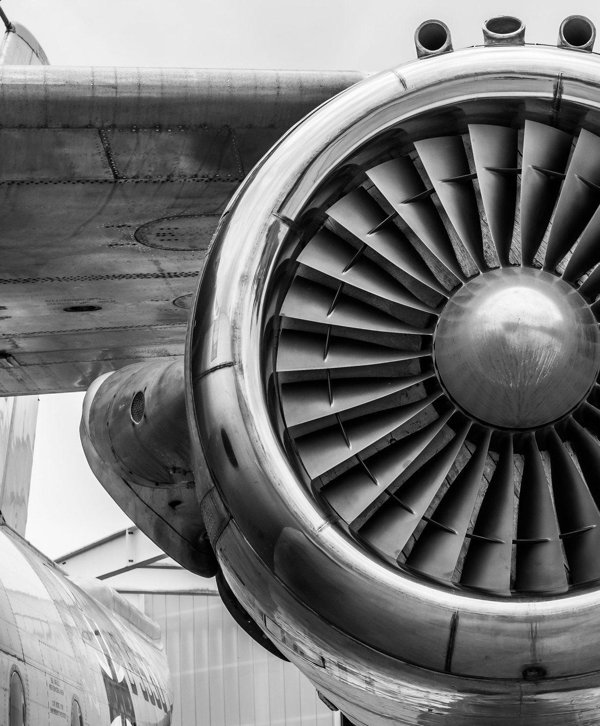 Turbofan intake with fan blades glowing at the hub on a white nacelle