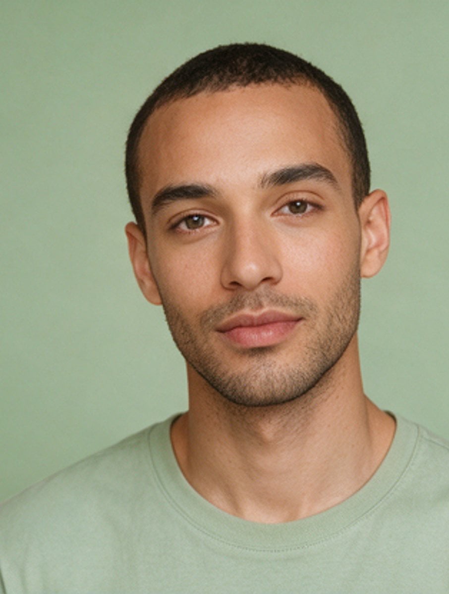 Studio portrait against a sage green backdrop