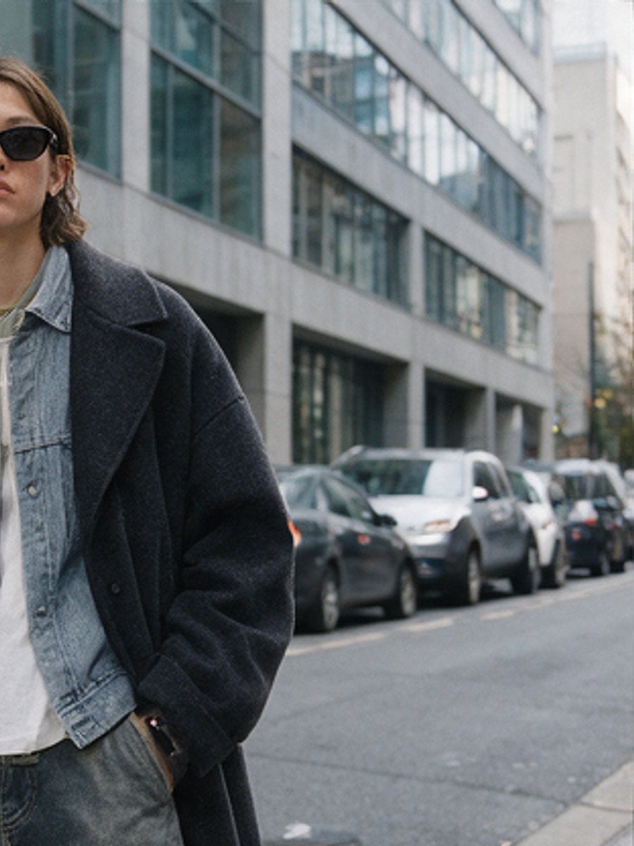Two friends in denim on a city sidewalk
