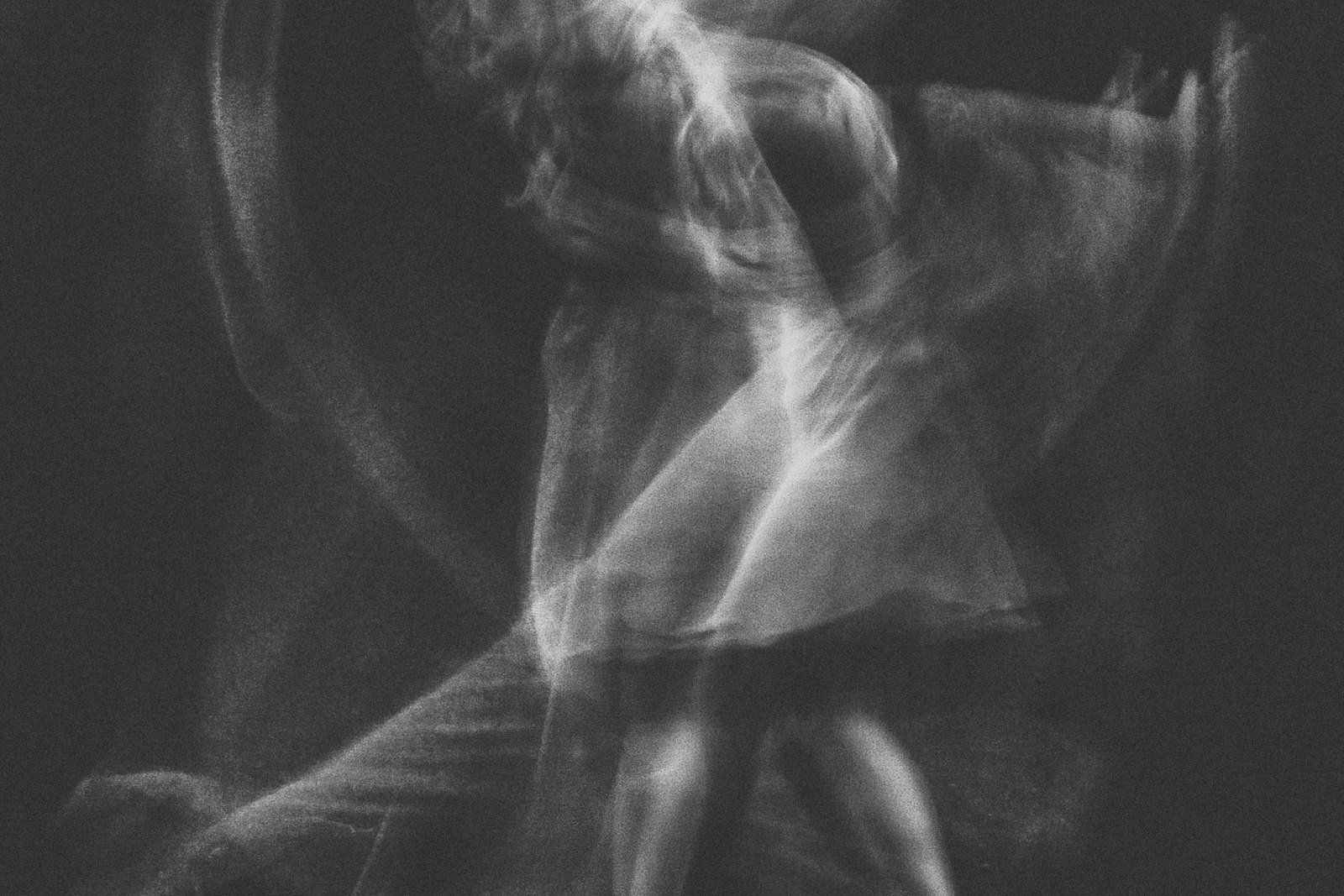 Solo dancer dissolving into a long-exposure blur