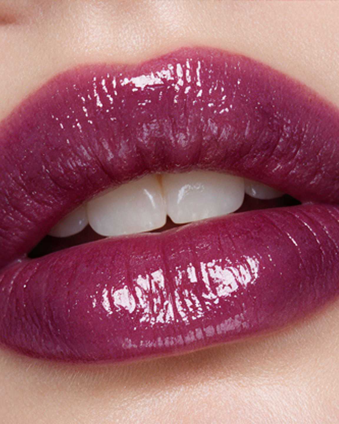Lips in glossy plum, teeth just visible