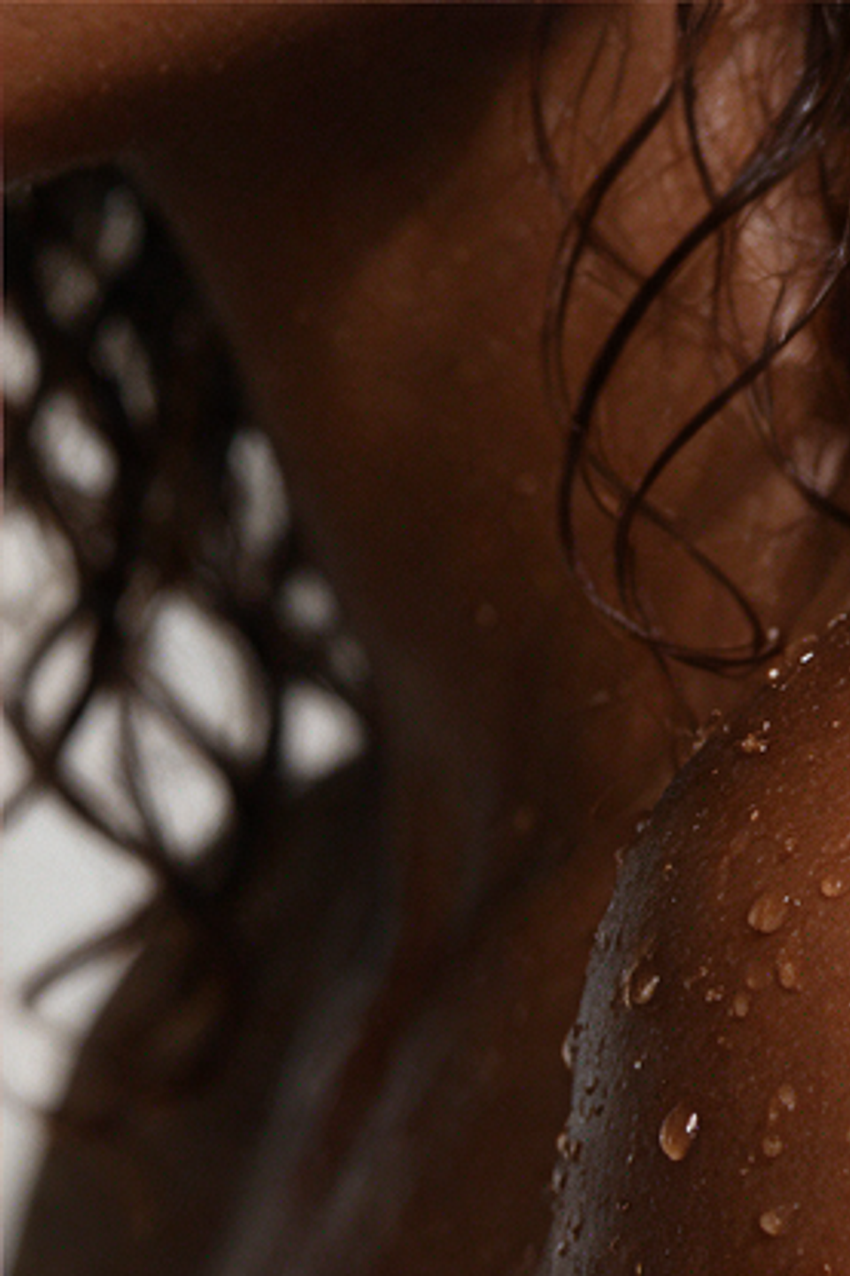 Water beading on a wet shoulder and neck