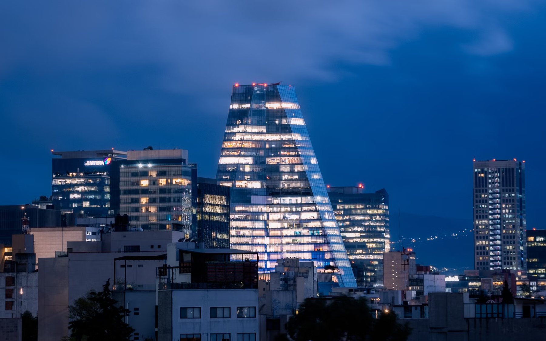 Skyline glowing under a deep blue evening sky