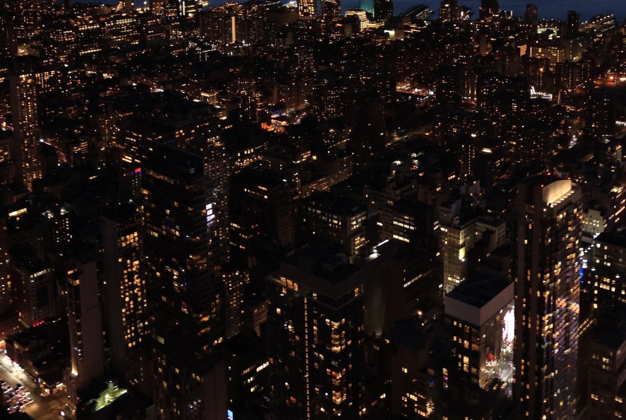 City of lit windows seen from above at night