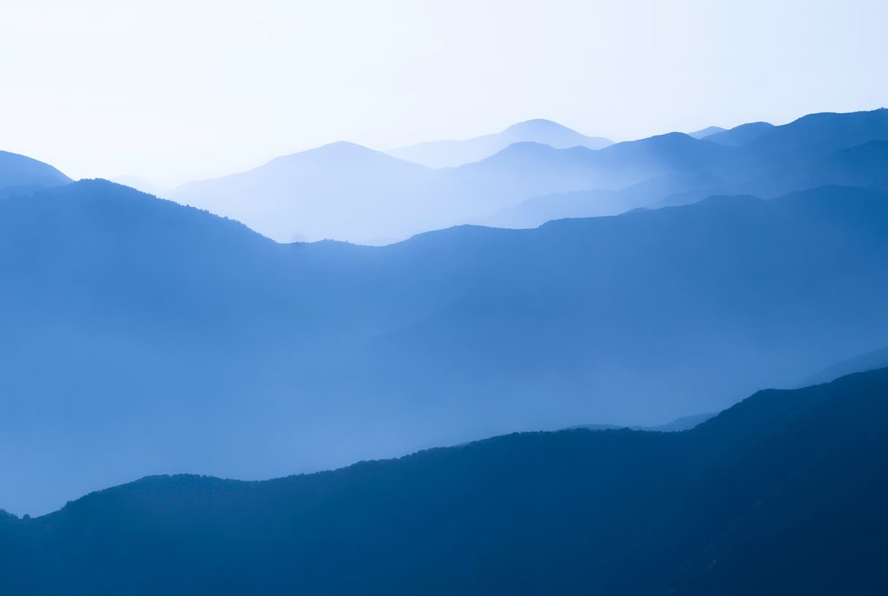 Blue mountain ridges fading into haze