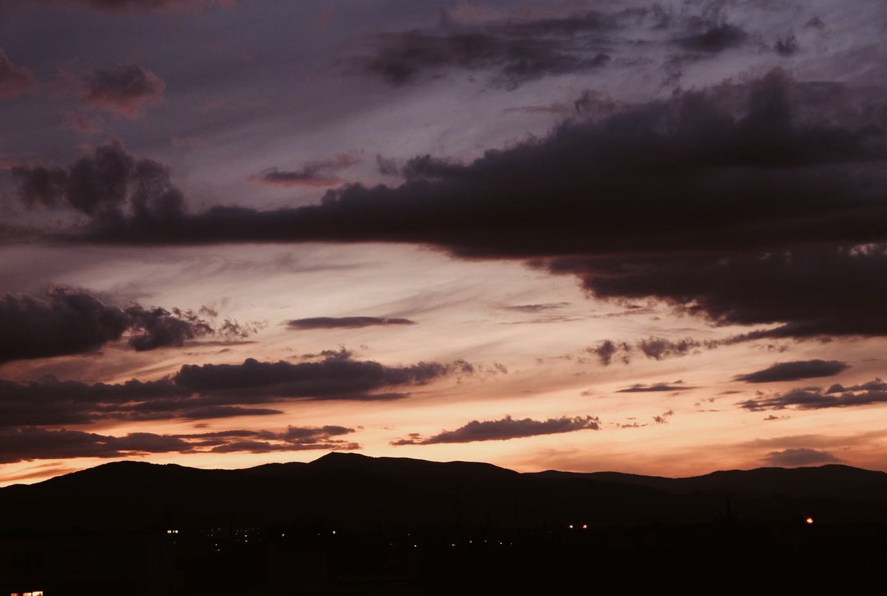 Dark clouds over hills after sundown