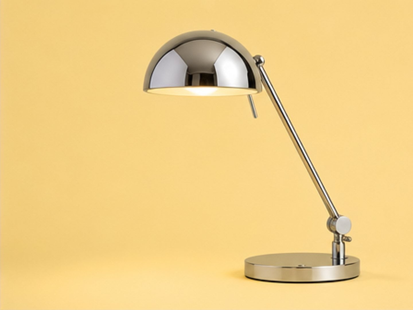 Chrome desk lamp on yellow