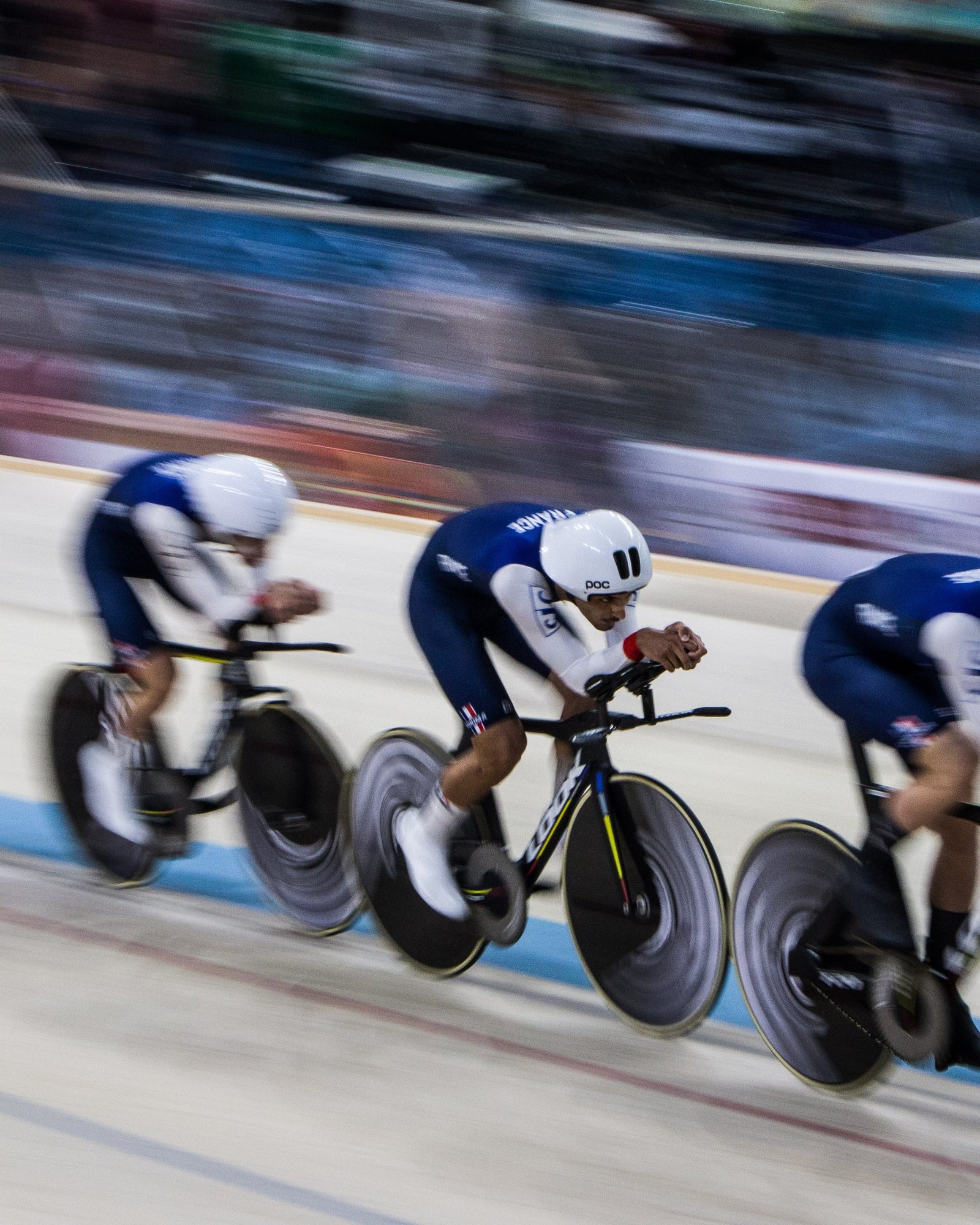 Team pursuit squad at speed, panned motion blur on the velodrome straight