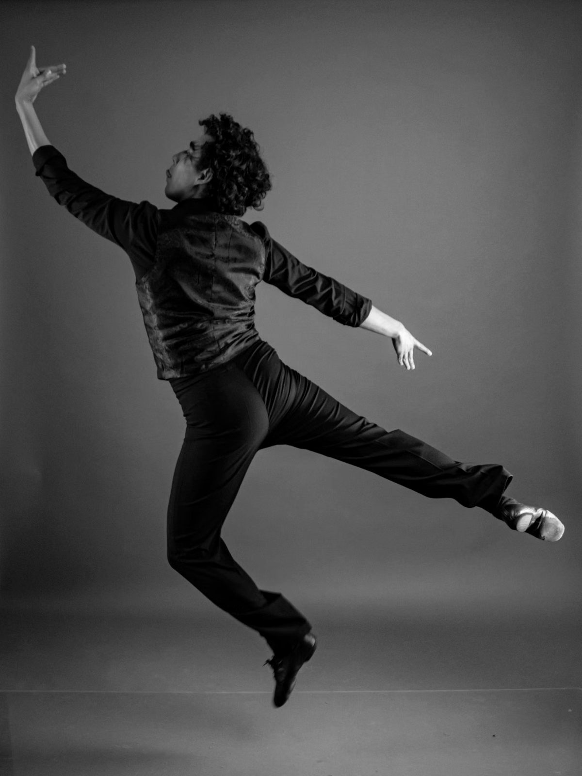 Dancer mid-jump, legs folded