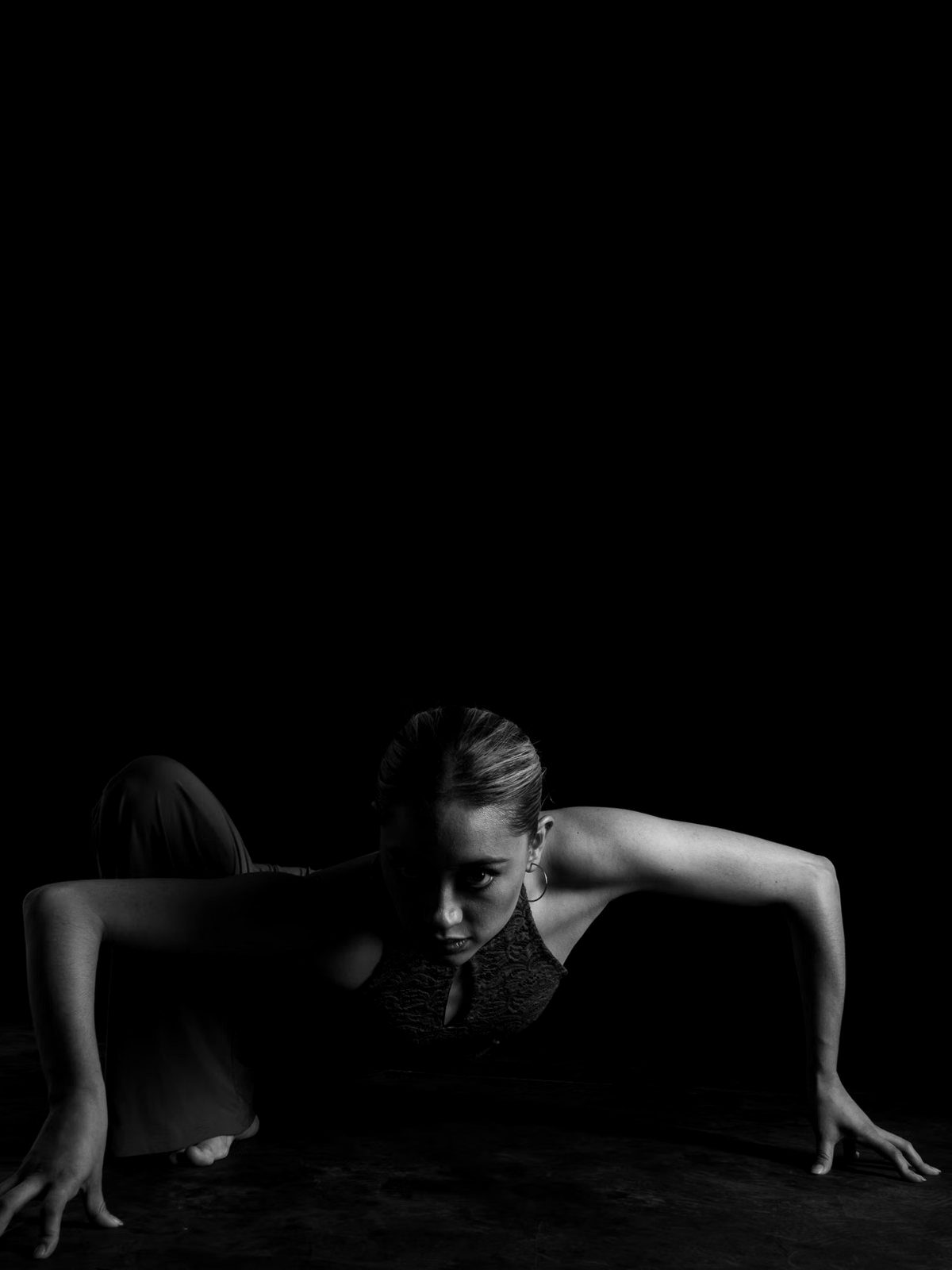 Dancer low to the floor, reaching forward