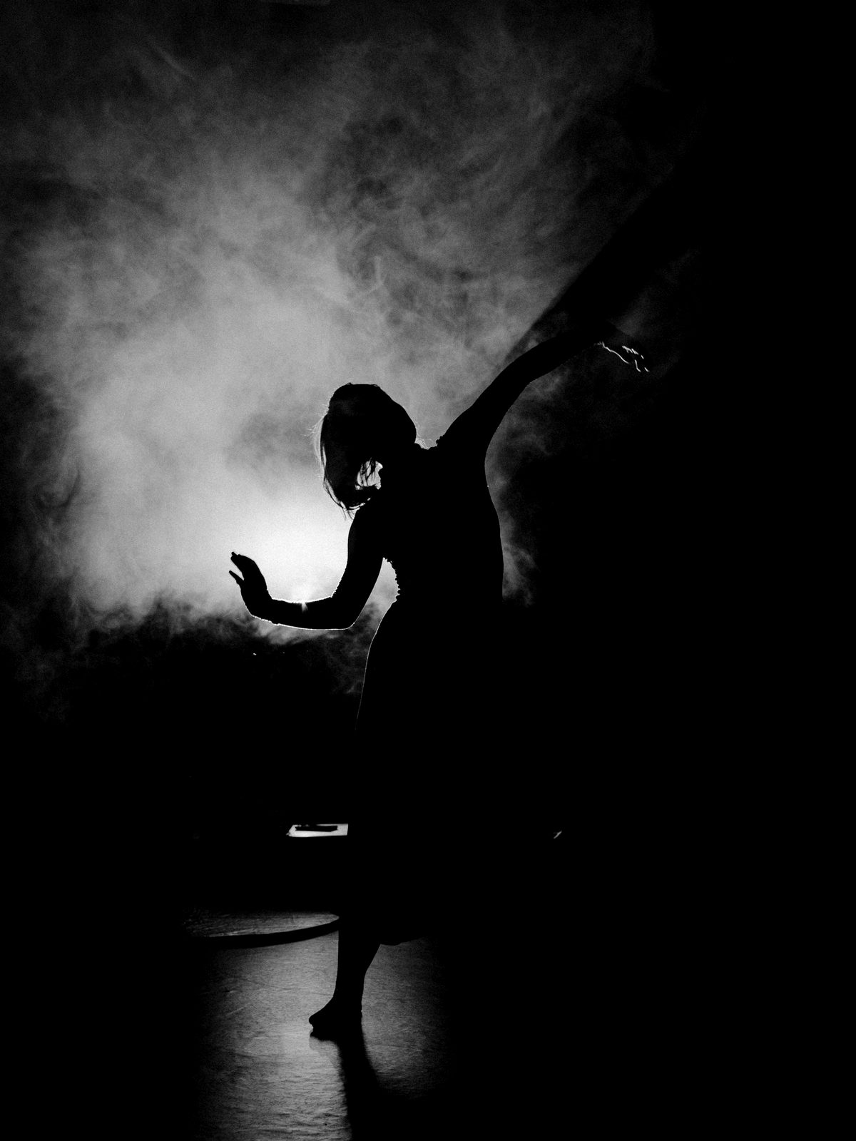 Silhouette in smoke, arms raised