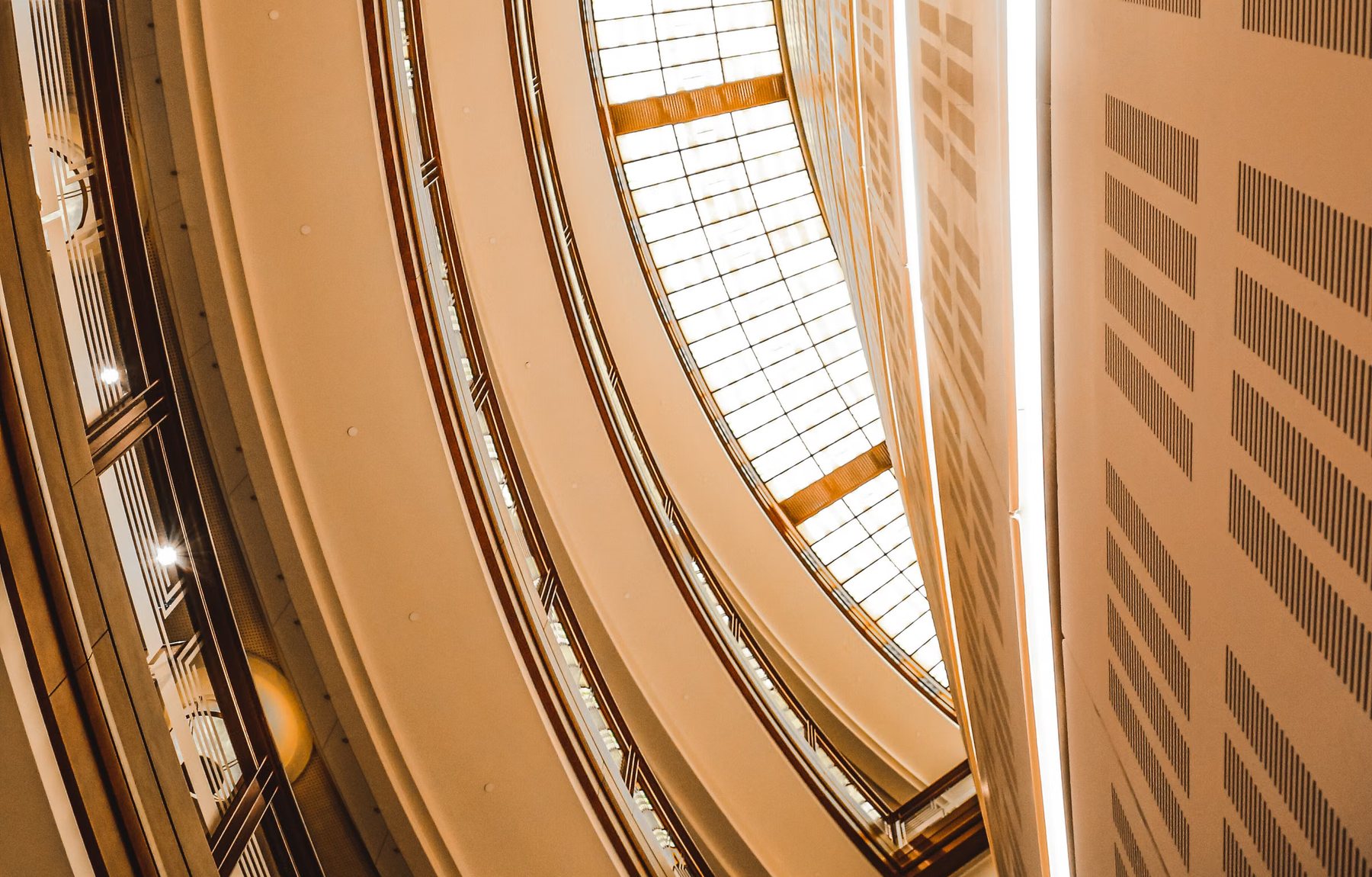 Curved atrium spiralling up toward a glazed roof