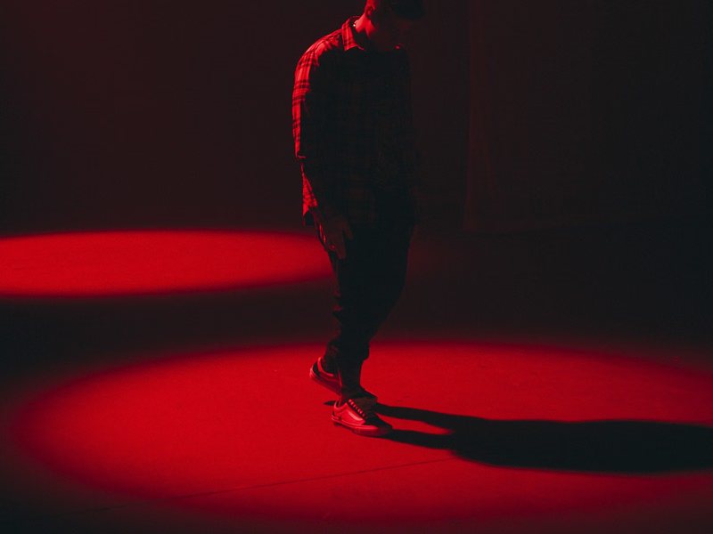 Lone figure in a red pool of light