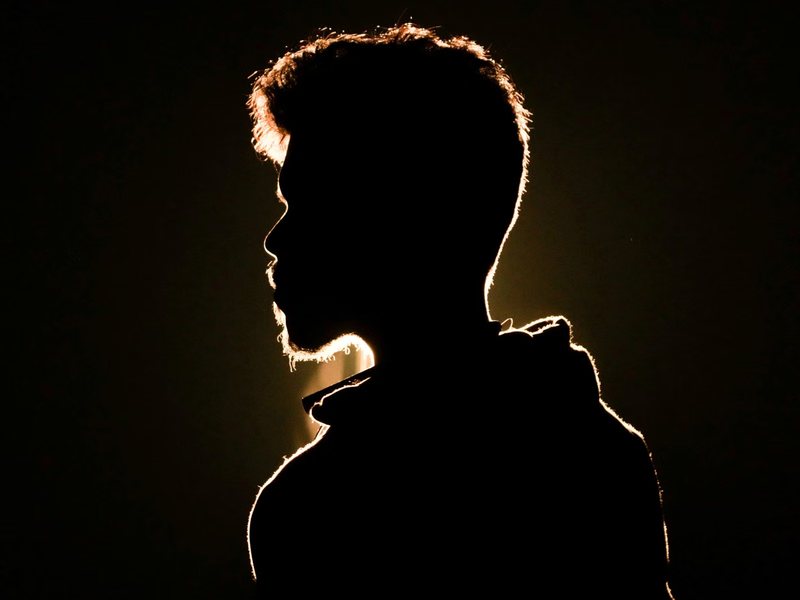 Head in profile against gold light