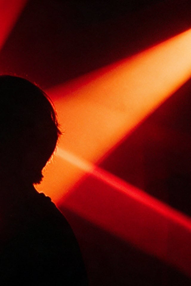 Silhouette split by a red light ray