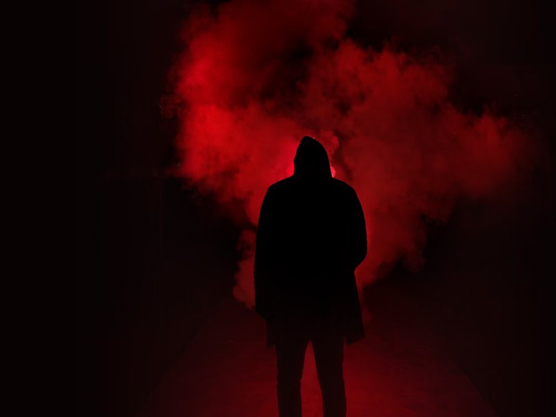 Silhouette standing in red smoke