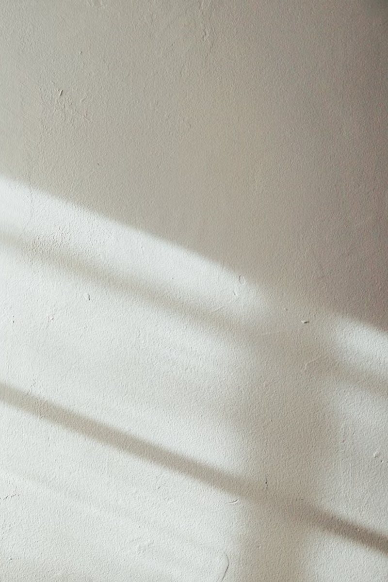 Warm afternoon light raking across a plaster wall
