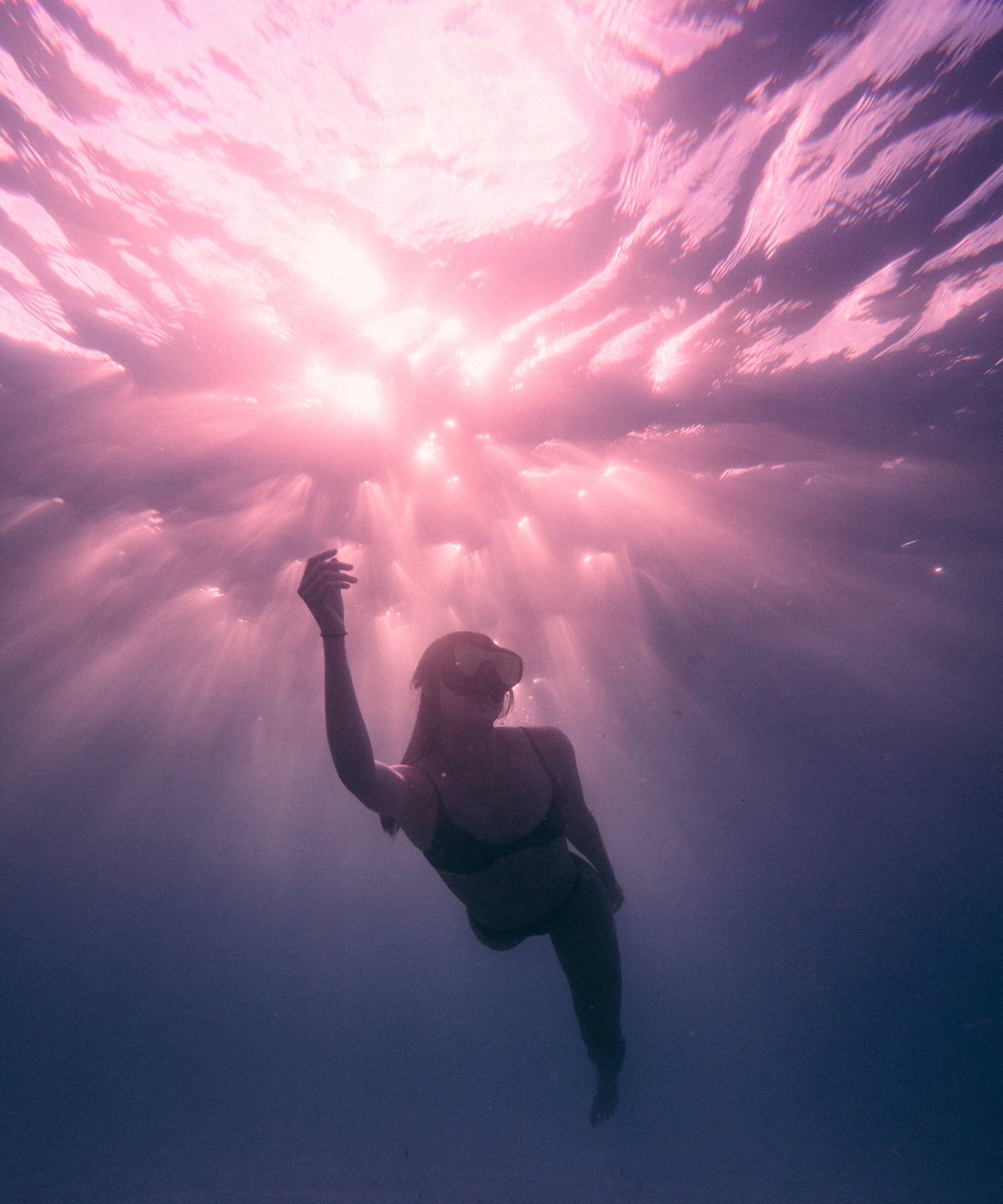 Still from Still water — a swimmer rising toward pink light