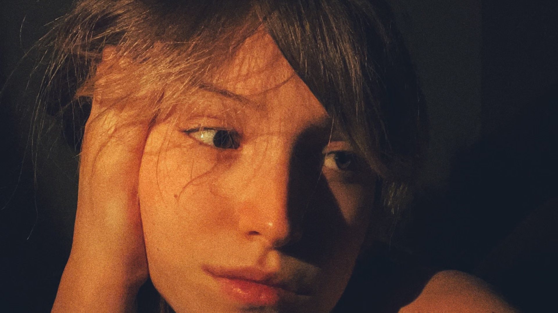 Close, low-light portrait of a woman