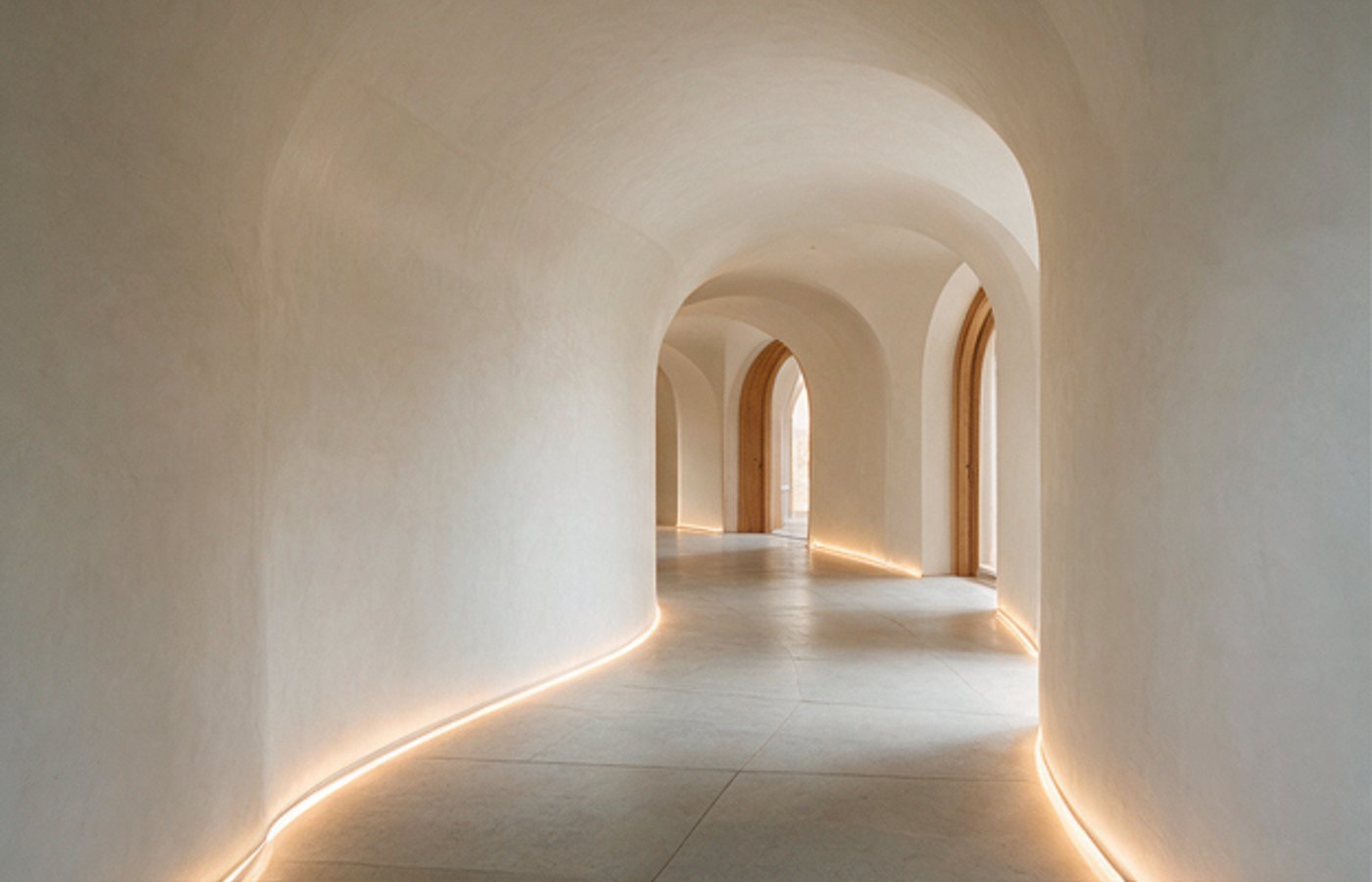 Curved white corridor washed in soft light