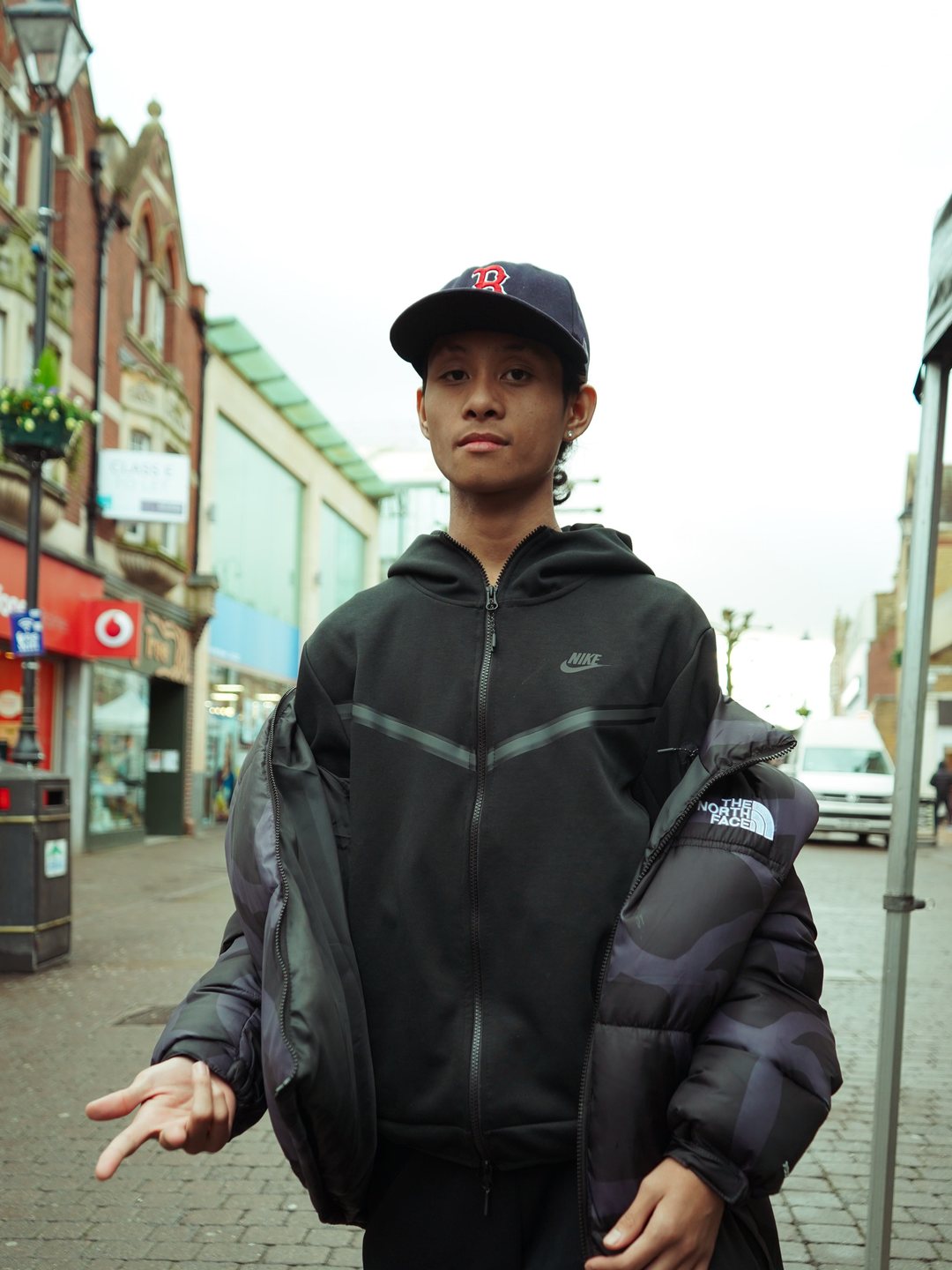 Tech fleece zip-up layered under a puffer on the high street