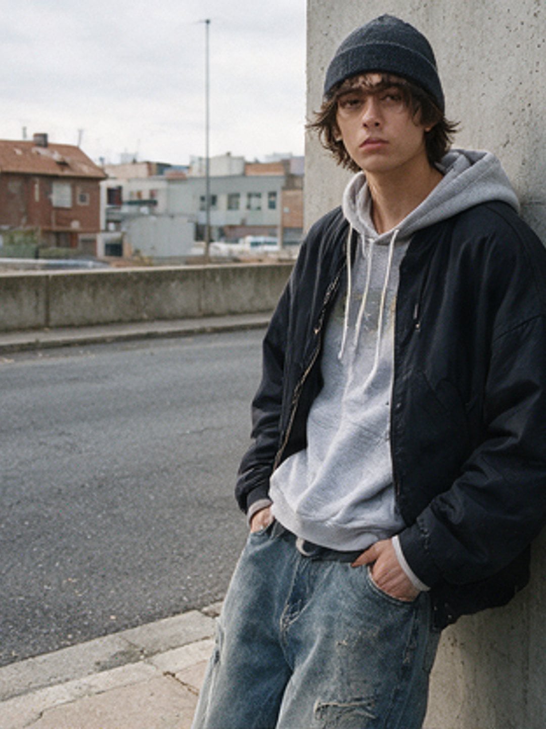 Cotton hoodie under a work jacket against a concrete wall