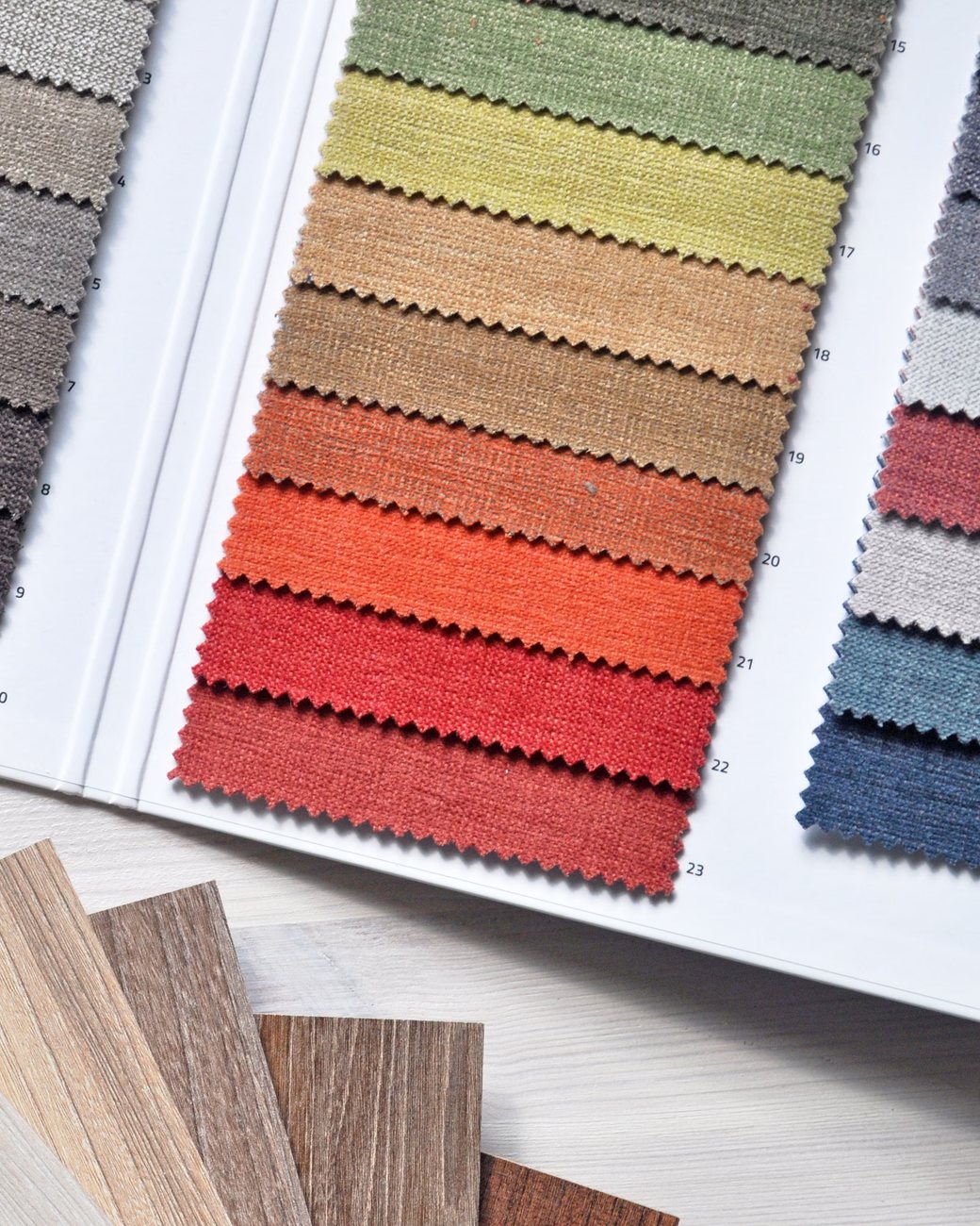 Colour and material swatches fanned across a desk