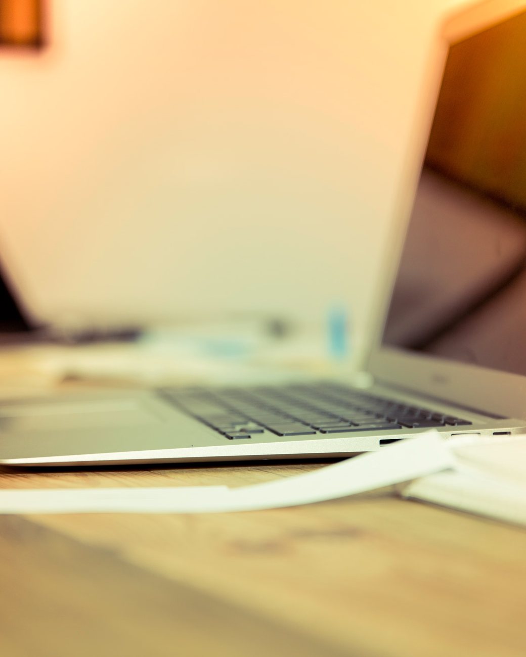 Laptop open on a warm-lit studio desk