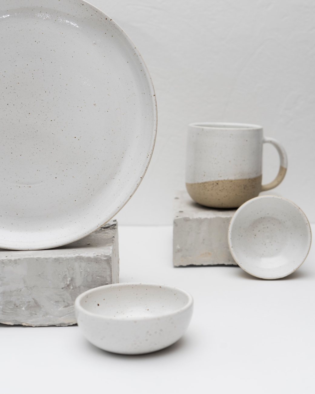 Ceramic objects arranged on studio plinths