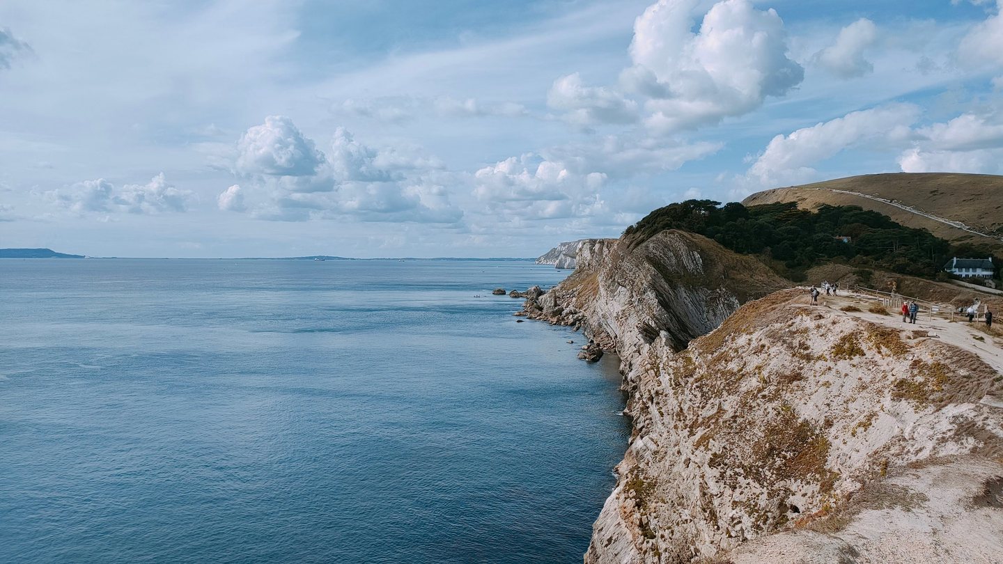 Rugged coastline of cliffs meeting the open sea in the afternoon
