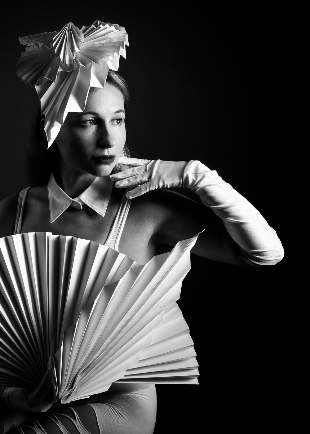 Model in a pleated paper collar, studio portrait
