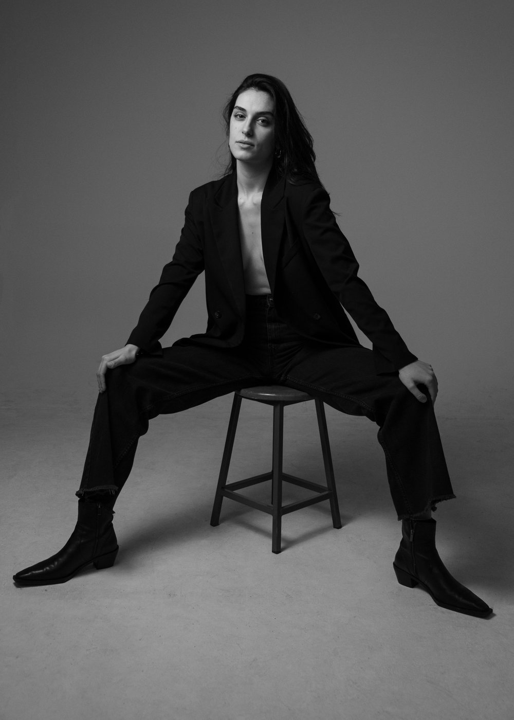 Model seated in a tailored suit