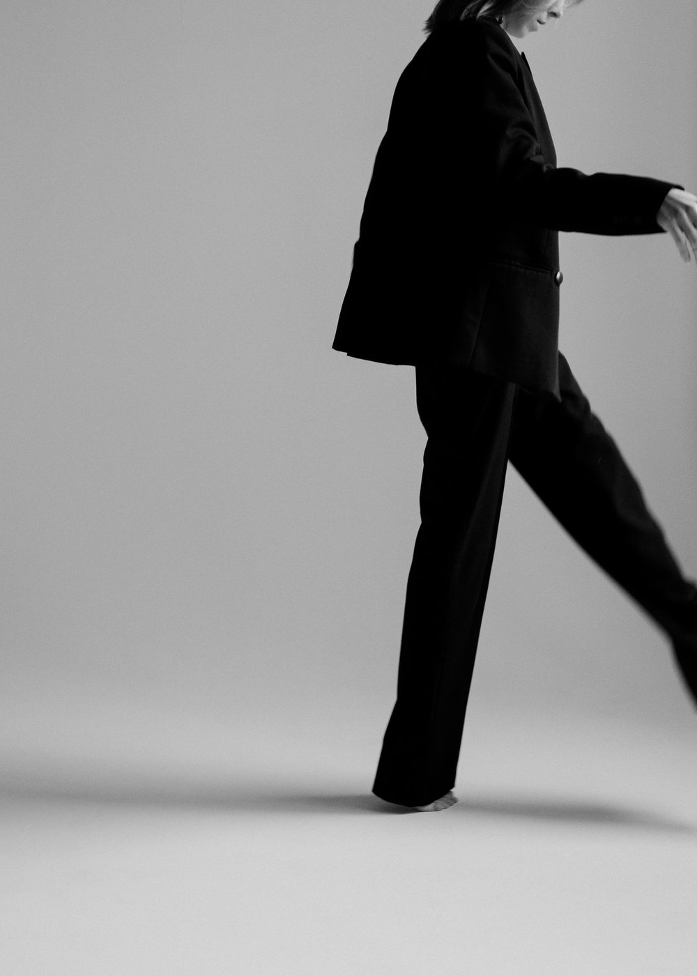 Model walking in wide black trousers