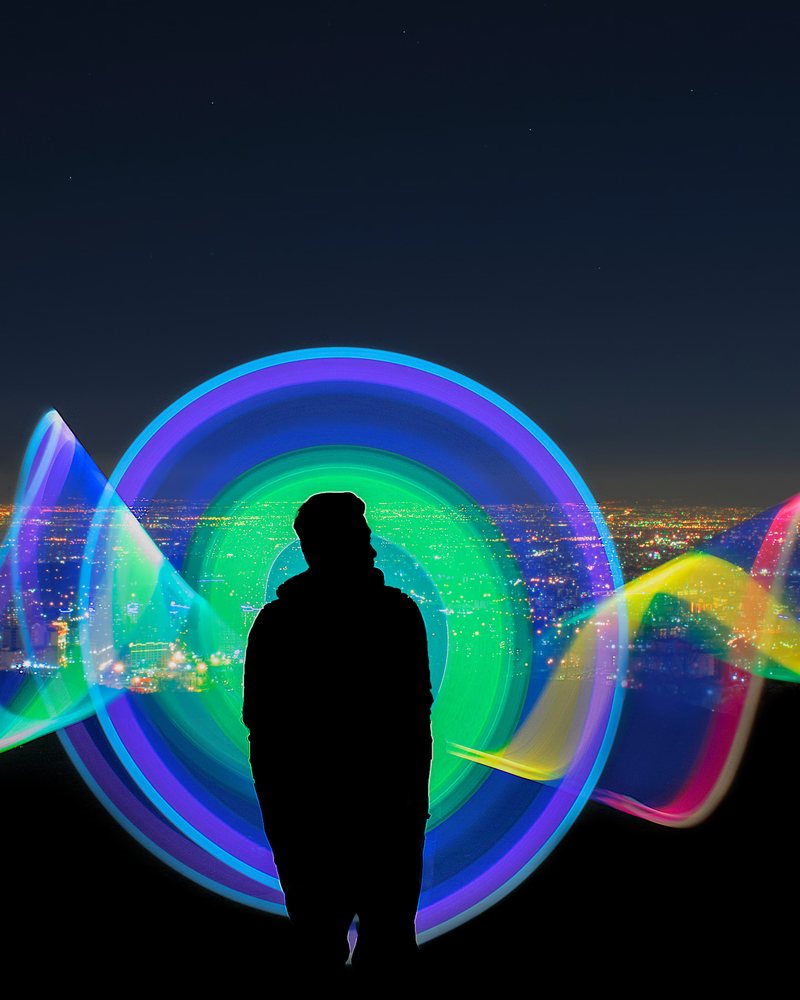 Silhouette against a neon light installation