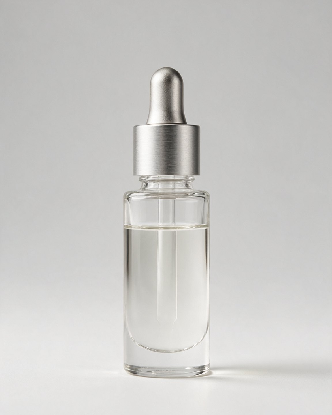 Clear glass facial oil bottle with silver dropper