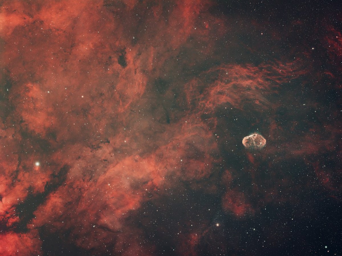 Crimson nebula drifting across deep space