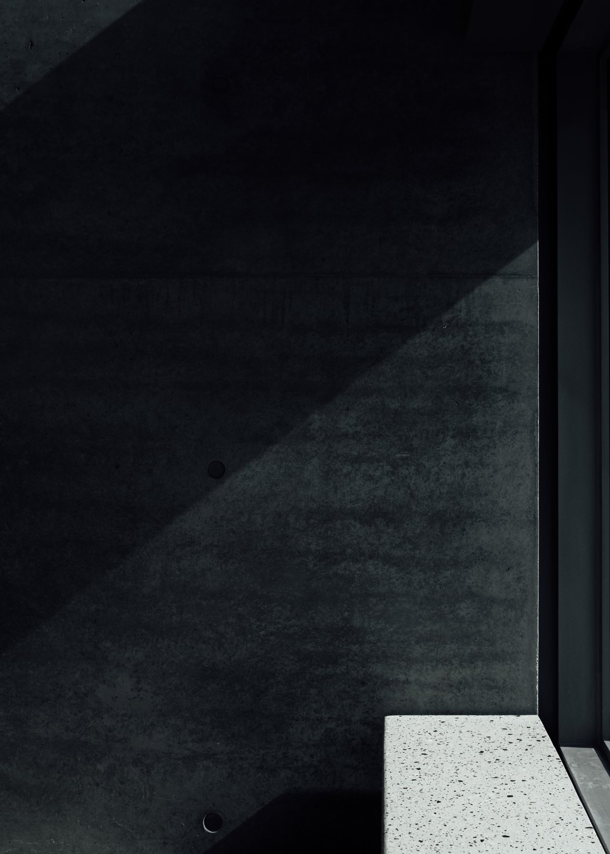 Light and shadow across a concrete wall in Nuvoro's studio