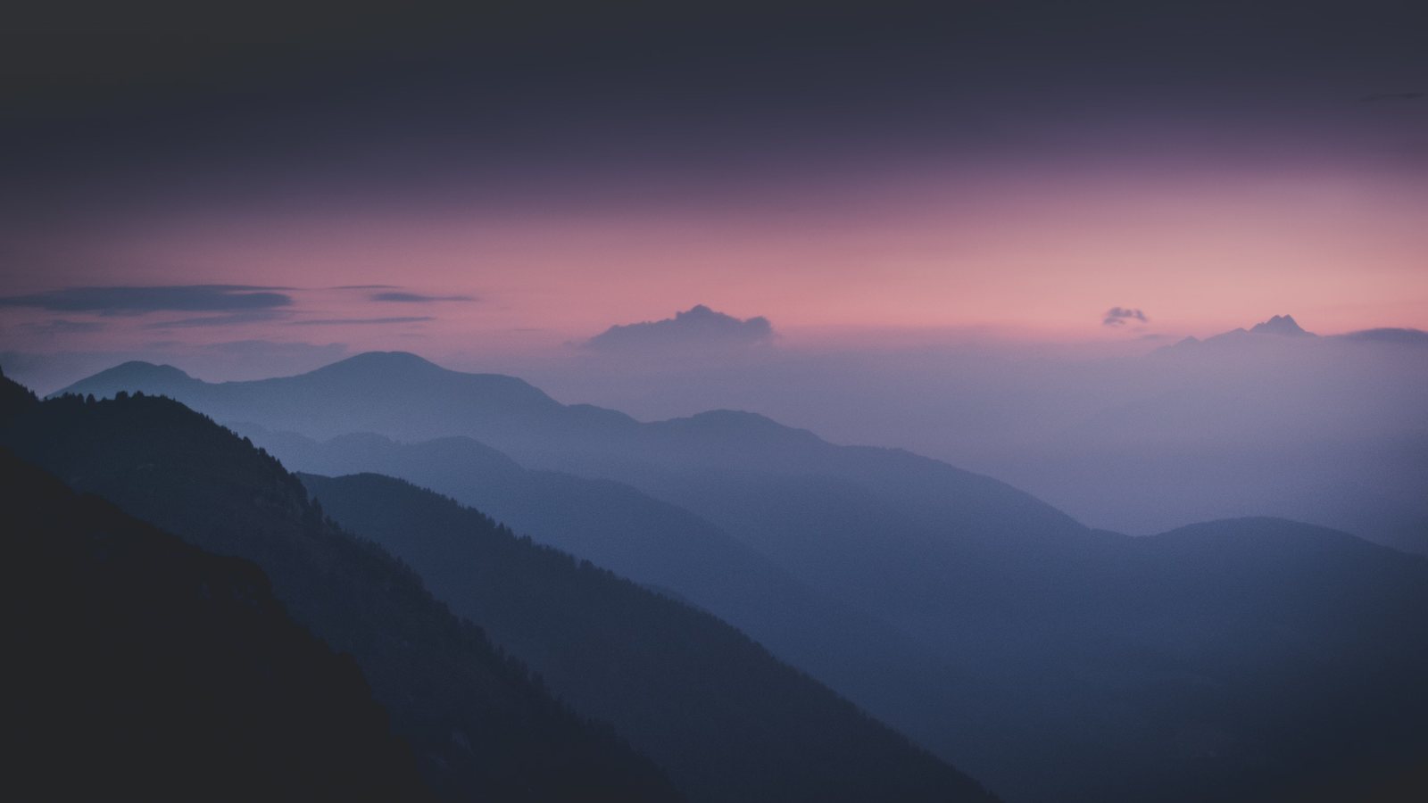 Layered mountain ridges at blue hour