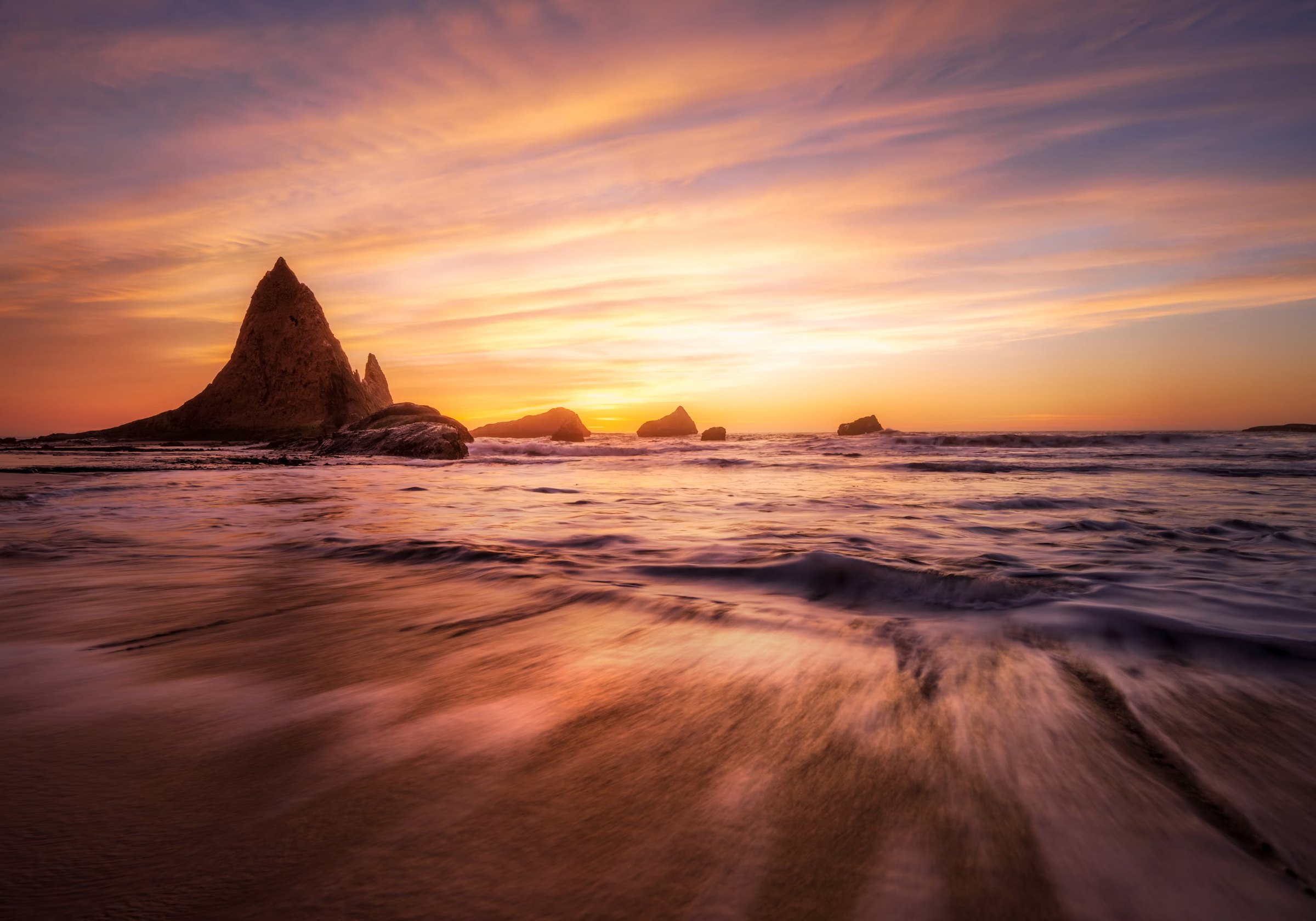Sea stacks along a rocky coastline at last light
